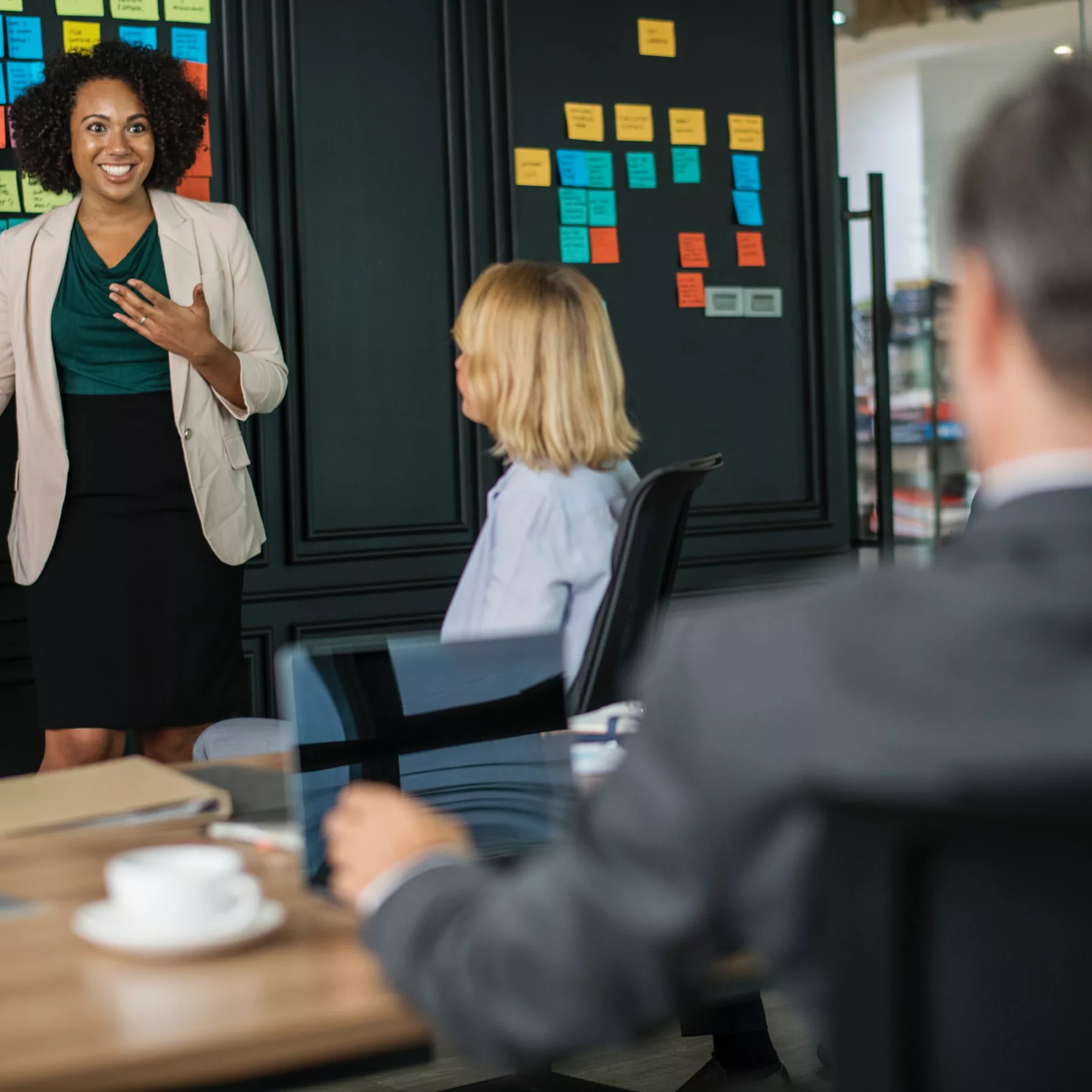woman presenting in front of her HR team