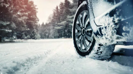 snowy car tires driving in the snow