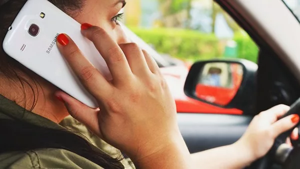 woman using her phone while driving