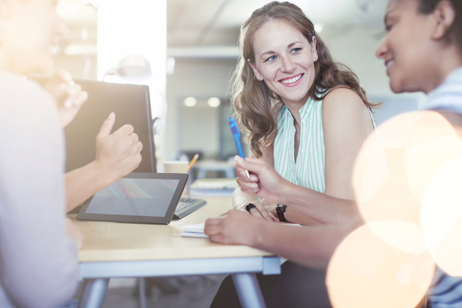 women smiling in a business meeting