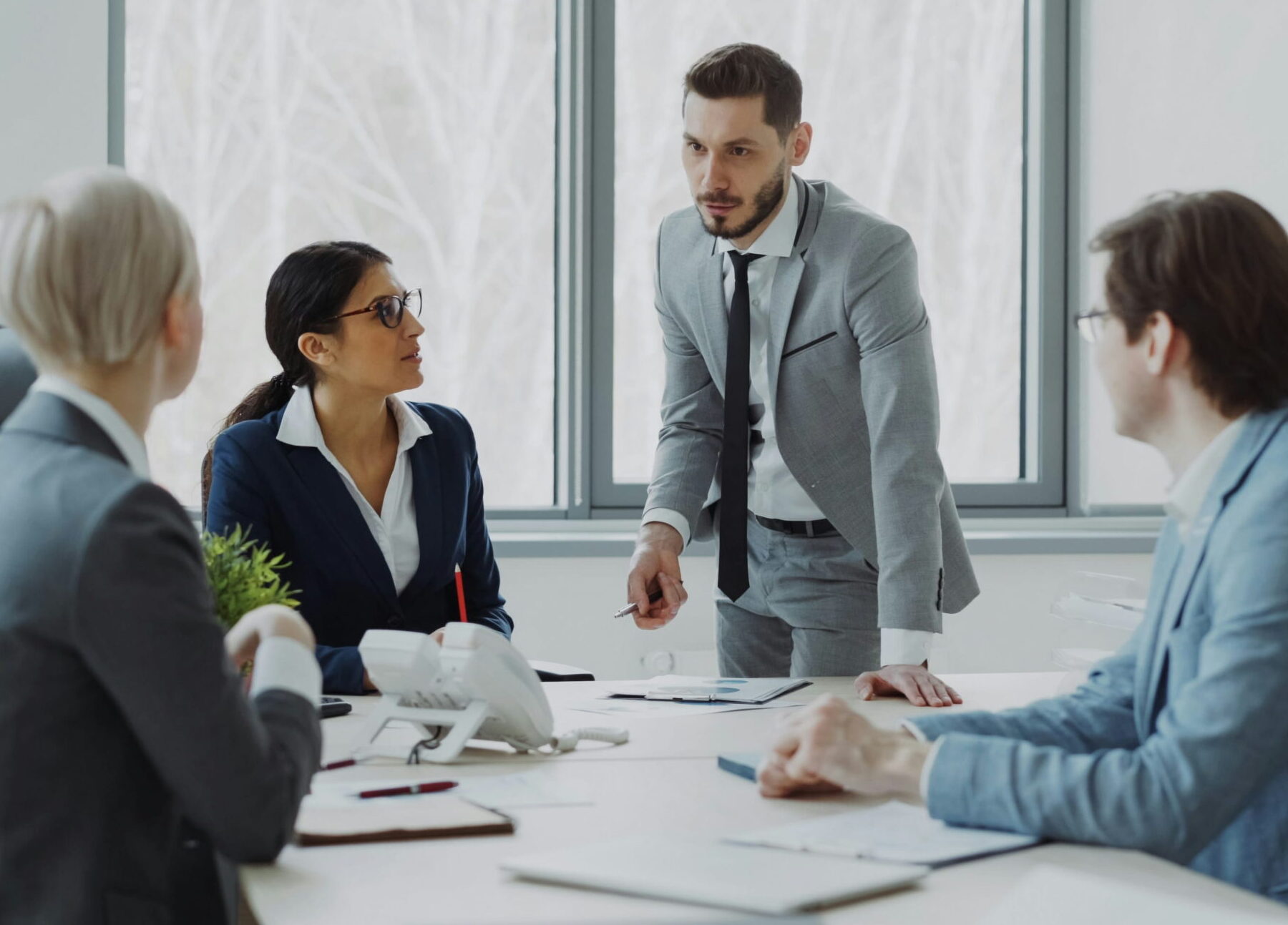 four business people having discussion in conference room