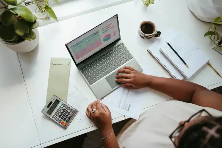 hr professional using laptop and calculator at desk