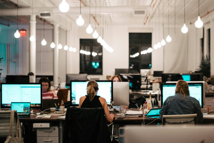 employees in open concept office space at night
