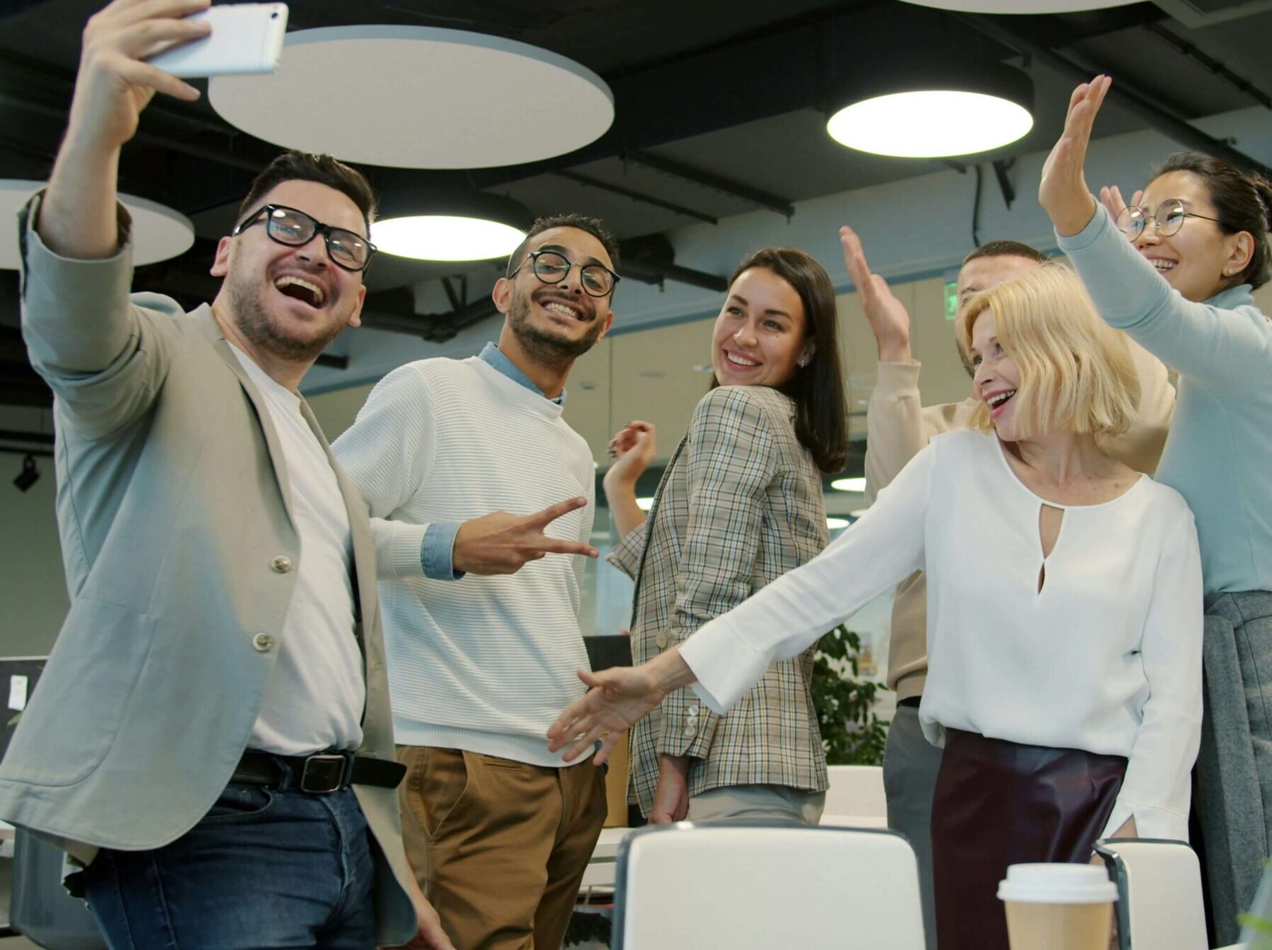 work colleagues excitedly posing for a photo together