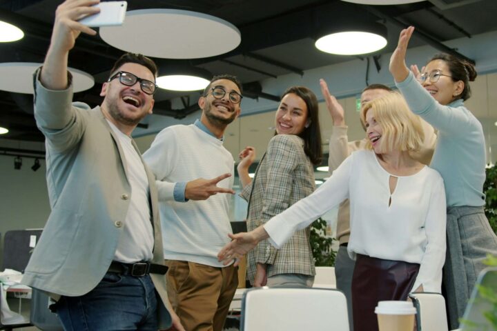 work colleagues excitedly posing for a photo together