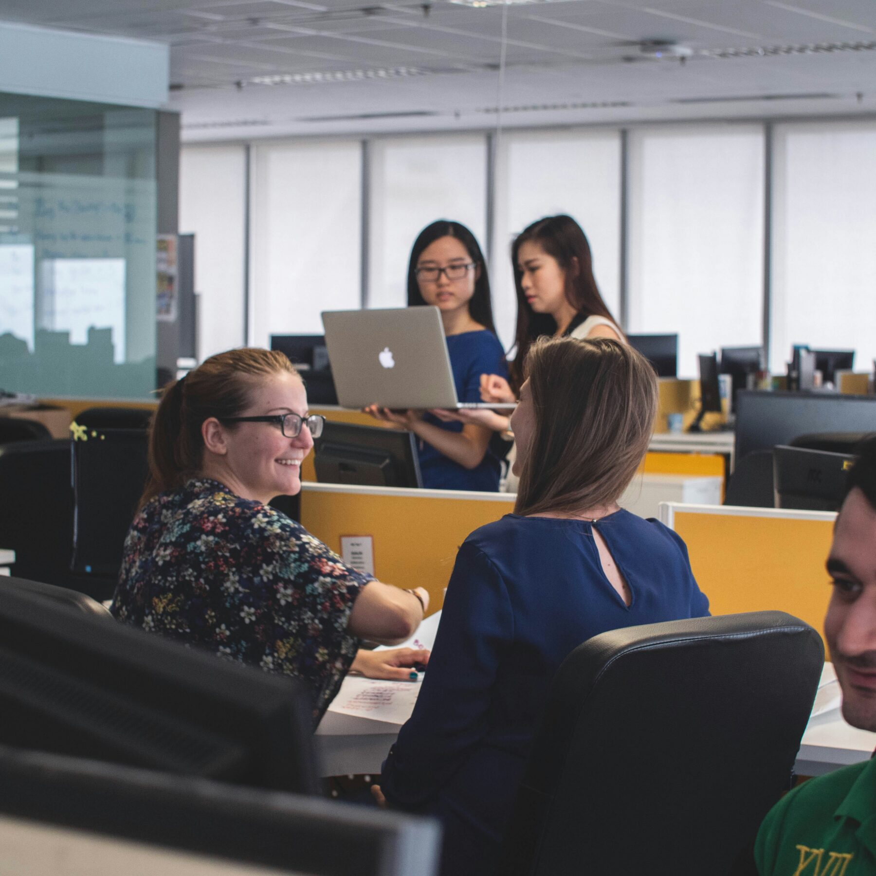 coworkers in open office workspace