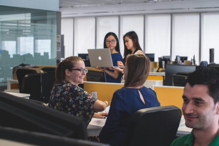 coworkers in open office workspace