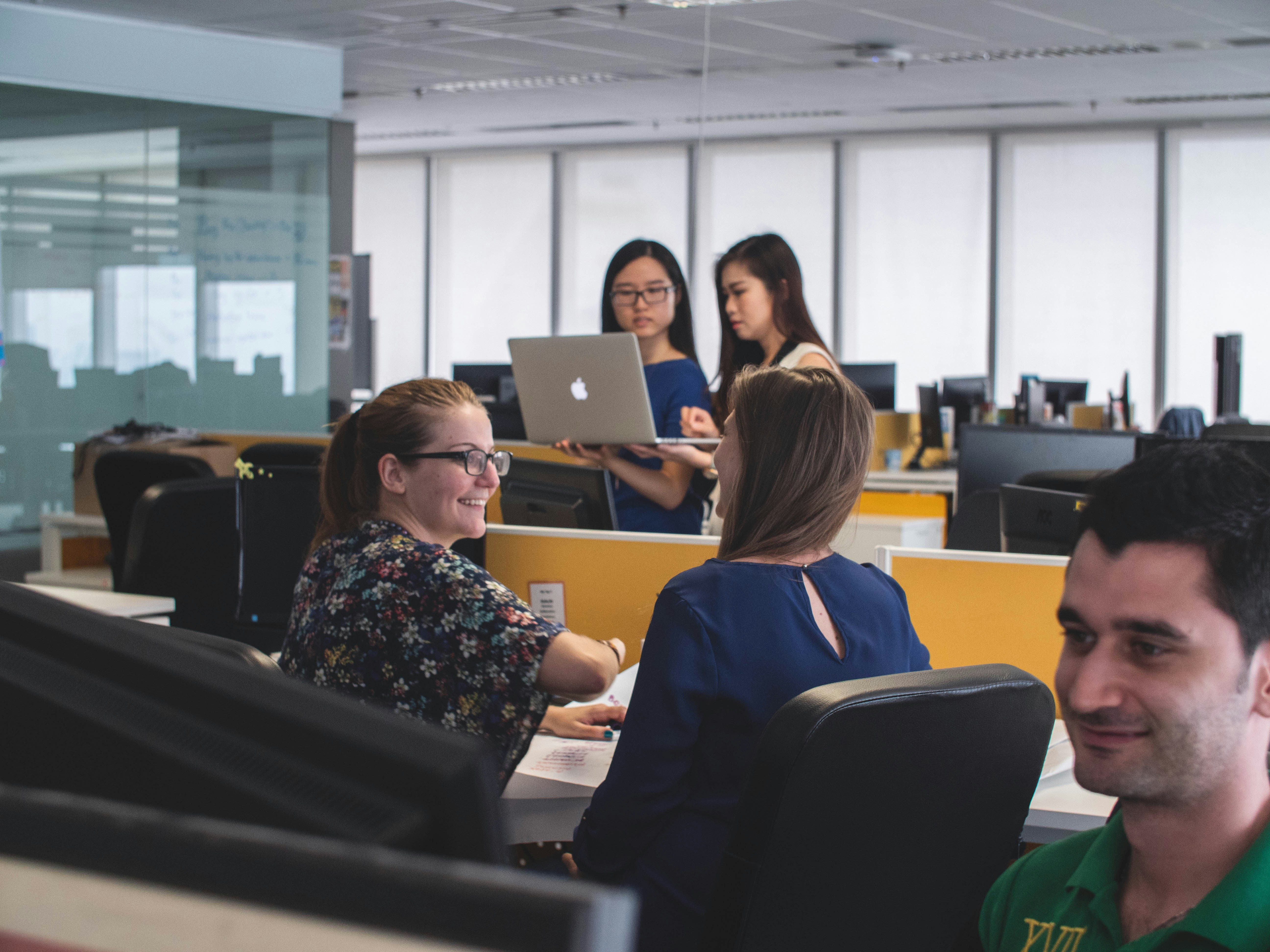 coworkers in open office workspace